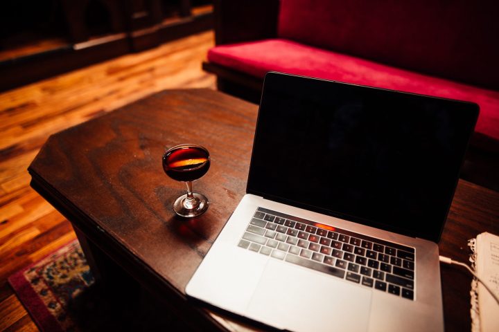a laptop computer sitting on top of a wooden table
